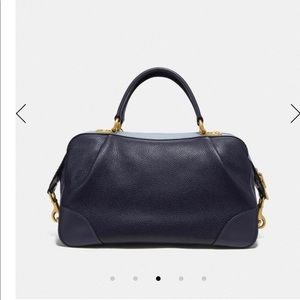 Coach navy blue handbag with light blue trim.